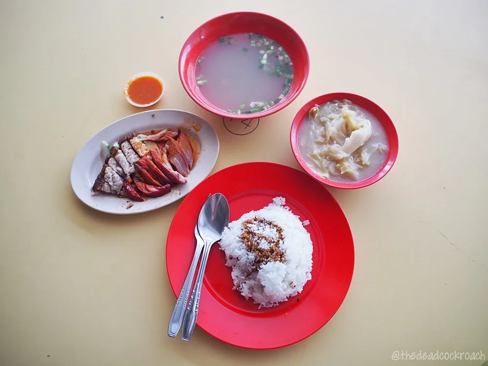 The Happy World Roast set for one: a plate of char siew and roasted pork, a plate of rice, a bowl of soup and a bowl of cabbage