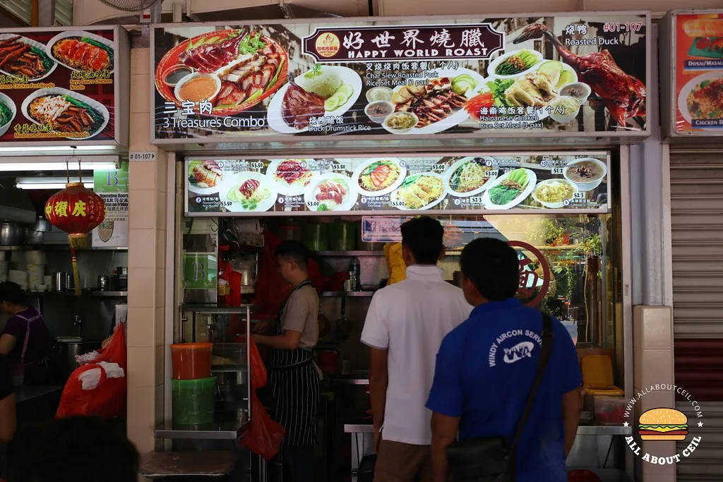 The Happy World Roast shopfront at Empress Road Market, with the 好世界 燒臘 signboard, the Three Treasures Combo poster and customers queuing at the counter
