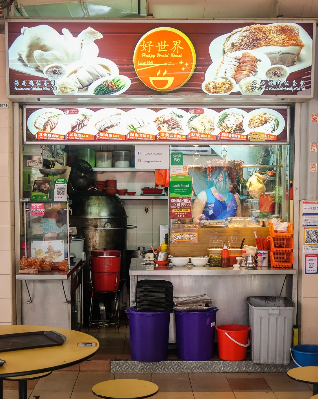The Happy World Roast shopfront at Empress Road Market, with the 好世界 logo signboard above and the lit numbered menu strip below